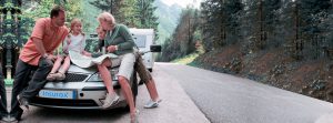 Travel - family with camping car on the road