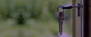Keys and lock the door on the background of solar garden